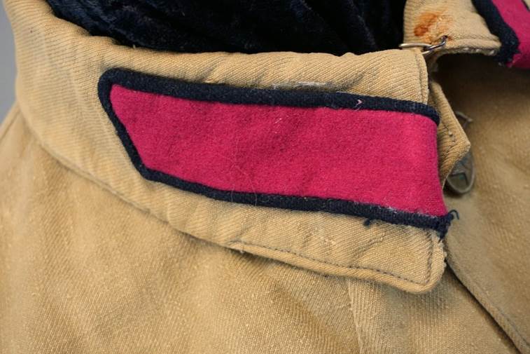 A close-up of a red patch on a brown pants

AI-generated content may be incorrect.