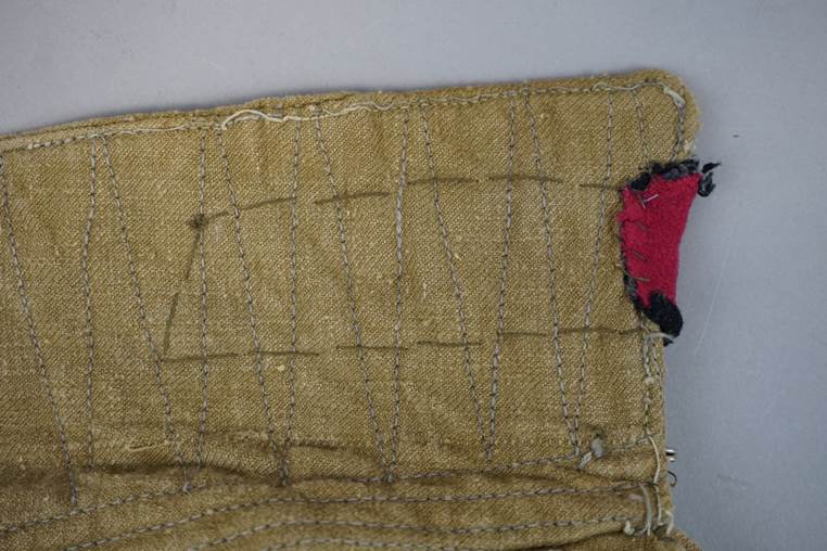 A piece of fabric with a red patch

AI-generated content may be incorrect.