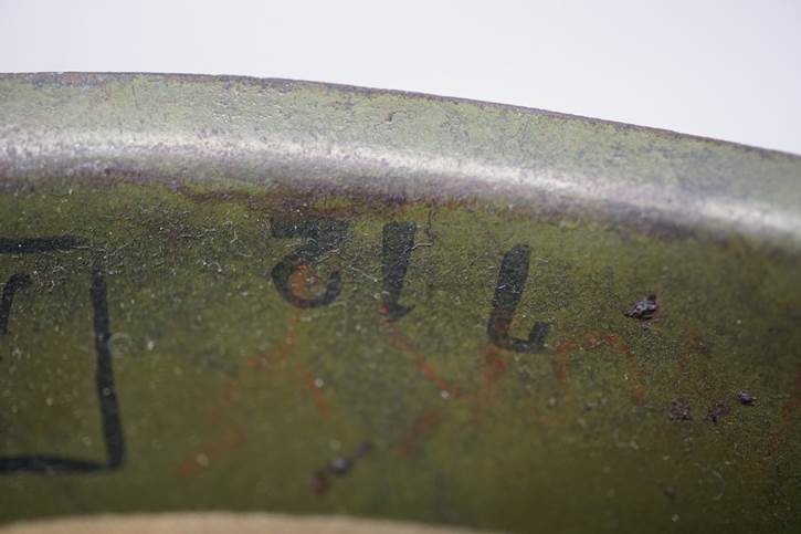 A close-up of a green metal surface

AI-generated content may be incorrect.