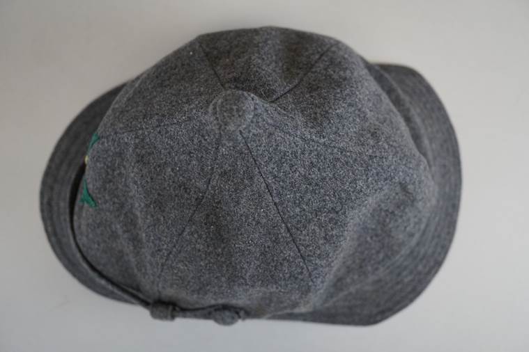 A grey hat on a white surface

AI-generated content may be incorrect.