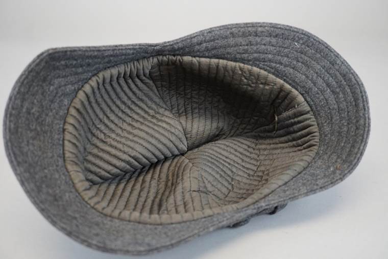 A grey hat with a hole in the middle

AI-generated content may be incorrect.