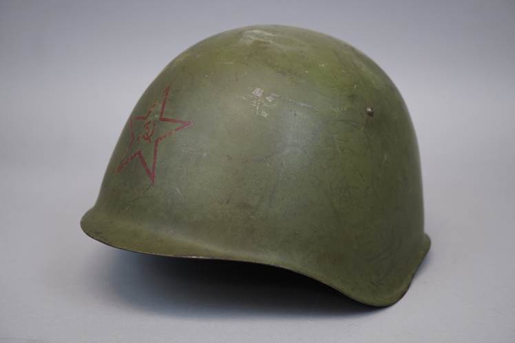 A green helmet with a red star

AI-generated content may be incorrect.