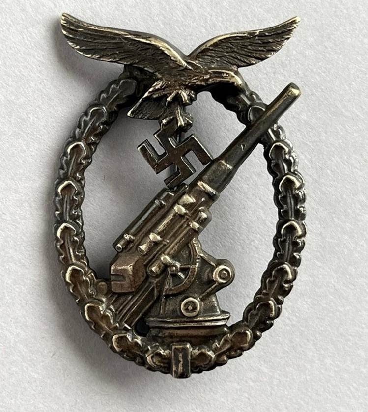 A metal badge with an object and a eagle

AI-generated content may be incorrect.