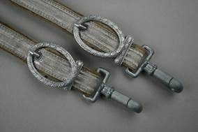 A pair of belts with metal rings

Description automatically generated