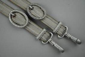 A pair of belts with metal rings

Description automatically generated