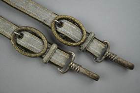 A pair of belts with rings

Description automatically generated
