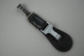 A black leather strap with a silver metal clasp

Description automatically generated