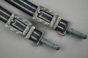 Close-up of a strap with metal buckles

Description automatically generated