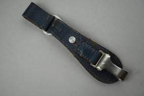 A leather strap with a metal clasp

Description automatically generated