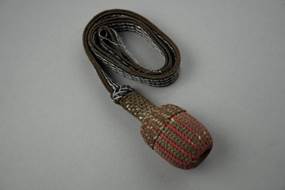 A green and orange rope with a strap

Description automatically generated