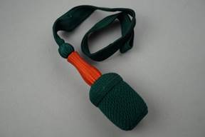 A green and orange rope with a strap

Description automatically generated