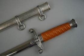 A picture containing wall, weapon, sword, chain

Description automatically generated