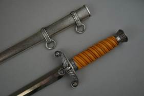 A picture containing wall, indoor, weapon, sword

Description automatically generated