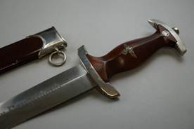 A knife with a handle and a sheath

Description automatically generated