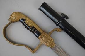 A sword and sheath on a table

Description automatically generated