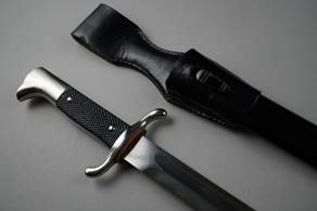 A knife and sheath on a table

Description automatically generated