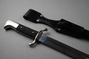 A knife and sheath on a table

Description automatically generated