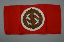 A red flag with a white circle and a brown symbol

Description automatically generated