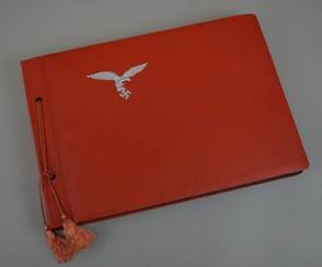 A red book with a white bird on it

Description automatically generated