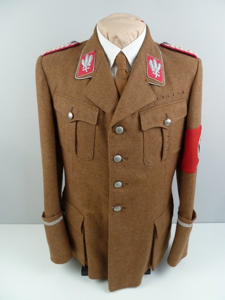A picture containing military uniform, clothing, wall, luggage

Description automatically generated