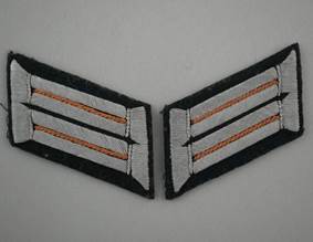 Close-up of a striped uniform insignia

Description automatically generated
