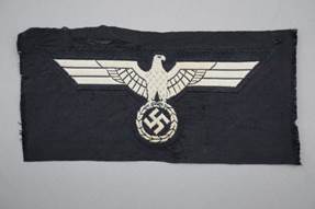 A black patch with a white eagle and a swastika

Description automatically generated