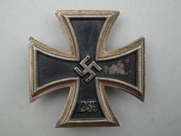 A black and silver cross with a crown

Description automatically generated