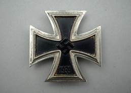 A silver badge with an object and laurel wreath

Description automatically generated