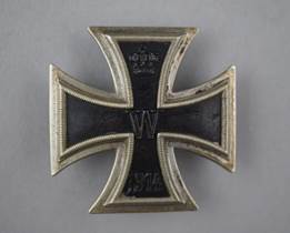 A metal eagle with a swastika in the middle

Description automatically generated