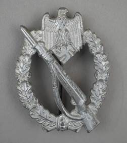 A silver badge with an object and laurel wreath

Description automatically generated
