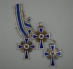 A group of medals with a symbol on them

Description automatically generated