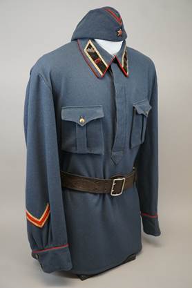A blue uniform with a belt

Description automatically generated