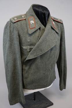 A military jacket on a mannequin

Description automatically generated